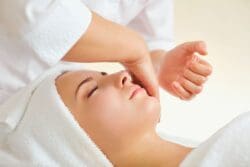 woman moisturizing after dermaplaning in hamilton nj