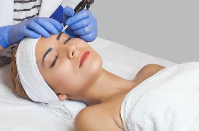 woman lying on a table with towels receiving a spa treatment MedSpa in Hamilton New Jersey